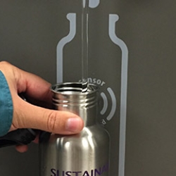 Reusable water bottle being filled 