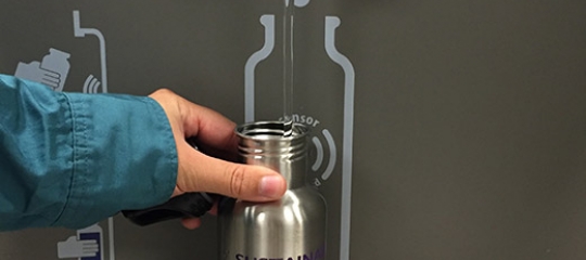 Reusable water bottle being filled 
